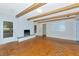 Bright living room featuring a cozy brick fireplace and wood beam ceilings at 320 25Th W St, Bradenton, FL 34205