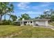 Home featuring a large screened in porch, one-car garage, and mature landscaping at 320 25Th W St, Bradenton, FL 34205