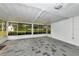 Bright sunroom with tiled flooring and a beautiful backyard view through large windows at 320 25Th W St, Bradenton, FL 34205