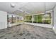Spacious sunroom with tiled flooring, a white ceiling, and large windows overlooking the backyard at 320 25Th W St, Bradenton, FL 34205
