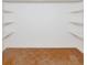 A bare walk-in closet features hardwood floors and white walls with shelving at 320 25Th W St, Bradenton, FL 34205