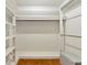 A spacious walk-in closet with hardwood floors and white shelving for storage at 320 25Th W St, Bradenton, FL 34205