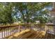 Wooden deck overlooking a serene fenced-in backyard with mature trees, perfect for outdoor entertaining at 3356 Maiden Ln, Sarasota, FL 34231