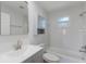 Modern bathroom with white tile, vanity storage, and a shower and tub combination at 3356 Maiden Ln, Sarasota, FL 34231