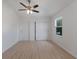 Bright bedroom with wood-look floors, ceiling fan, and closet at 3356 Maiden Ln, Sarasota, FL 34231