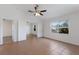 Airy bedroom with tile flooring, ceiling fan, and natural light from the large window at 3356 Maiden Ln, Sarasota, FL 34231