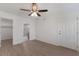 Bright bedroom with wood-look floors, ceiling fan, leading to bathroom with glass enclosed shower at 3356 Maiden Ln, Sarasota, FL 34231