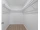 Bright walk-in closet with white wire shelving and wood-look laminate flooring at 3356 Maiden Ln, Sarasota, FL 34231