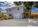 Two-story home featuring a wooden deck, light gray siding, garage, and concrete driveway at 3356 Maiden Ln, Sarasota, FL 34231