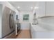Modern kitchen with stainless steel appliances, white cabinets, and quartz countertops at 3356 Maiden Ln, Sarasota, FL 34231