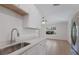 Modern kitchen with white cabinets, quartz countertops, and stainless steel appliances at 3356 Maiden Ln, Sarasota, FL 34231
