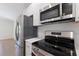 Updated kitchen with stainless steel appliances and modern black cooktop at 3356 Maiden Ln, Sarasota, FL 34231