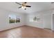 Open-concept living room featuring tile floors, ceiling fan, and bright natural lighting at 3356 Maiden Ln, Sarasota, FL 34231