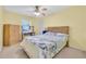 Bedroom featuring a ceiling fan, closet, desk, and light yellow colored walls at 337 Myrtle Ct, Palm Harbor, FL 34683