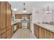 Bright kitchen featuring wood cabinets, white appliances, and a tiled floor at 337 Myrtle Ct, Palm Harbor, FL 34683