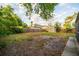 Large backyard with a wood fence, some trees, and a shed for additional storage at 3515 W Pearl Ave, Tampa, FL 33611