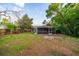 Spacious backyard with a picnic table, shed, well-maintained lawn, and secure fencing at 3515 W Pearl Ave, Tampa, FL 33611