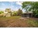 Expansive backyard featuring a screened patio, shed, and plenty of room for outdoor activities at 3515 W Pearl Ave, Tampa, FL 33611