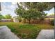 Backyard featuring a large shade tree, picnic table, shed and fenced perimeter at 3515 W Pearl Ave, Tampa, FL 33611