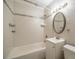 Modern bathroom featuring a shower-tub combo, a vanity, and stylish tiling at 3515 W Pearl Ave, Tampa, FL 33611