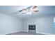 Bedroom featuring a ceiling fan, gray carpet, and decorative fireplace at 3515 W Pearl Ave, Tampa, FL 33611