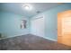 Inviting blue bedroom featuring natural light from a window and a double-door closet at 3515 W Pearl Ave, Tampa, FL 33611