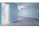 Large bedroom featuring gray carpet, ceiling fan, and bathroom access at 3515 W Pearl Ave, Tampa, FL 33611