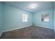 Light-filled bedroom painted in a soothing blue, with plush carpeting and two windows at 3515 W Pearl Ave, Tampa, FL 33611