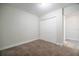 Cozy bedroom with neutral carpet, white walls, and a practical double-door closet at 3515 W Pearl Ave, Tampa, FL 33611