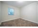 Simple bedroom with neutral carpet and natural light from window at 3515 W Pearl Ave, Tampa, FL 33611