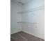 Organized closet space with white wire shelving, and neutral carpet at 3515 W Pearl Ave, Tampa, FL 33611