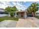 Charming home with a red front door, gray exterior, and palm tree at 3515 W Pearl Ave, Tampa, FL 33611