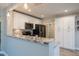 Open kitchen with bar top, granite countertops and modern appliances at 3515 W Pearl Ave, Tampa, FL 33611