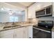 Modern kitchen with stainless steel oven, microwave, and granite countertops at 3515 W Pearl Ave, Tampa, FL 33611