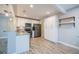 Contemporary kitchen with white cabinets, stainless steel appliances, granite counters and wood-look floors at 3515 W Pearl Ave, Tampa, FL 33611