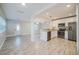Stylish kitchen featuring white cabinets, stainless steel appliances, and an open design connected to the living area at 3515 W Pearl Ave, Tampa, FL 33611