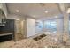 Granite countertops of kitchen looking into side room with window at 3515 W Pearl Ave, Tampa, FL 33611