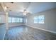 Bright living room with wood-look tile floors featuring kitchen bar at 3515 W Pearl Ave, Tampa, FL 33611