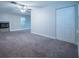 Spacious living room with a cozy fireplace, ceiling fan, and double door closet at 3515 W Pearl Ave, Tampa, FL 33611