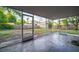 Screened porch overlooking a spacious backyard with storage shed at 3515 W Pearl Ave, Tampa, FL 33611