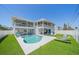 Beautiful backyard with a sparkling pool, covered patio, and lush artificial turf at 3711 118Th W St, Bradenton, FL 34210