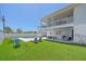 Beautiful backyard with a sparkling pool, covered patio, outdoor seating, and lush artificial turf at 3711 118Th W St, Bradenton, FL 34210