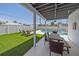 Inviting outdoor patio with dining area overlooking the pool and artificial turf at 3711 118Th W St, Bradenton, FL 34210