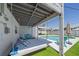 Outdoor lounging area with daybed swing overlooking a pool, patio and artificial turf at 3711 118Th W St, Bradenton, FL 34210
