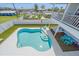 Private backyard featuring a kidney-shaped pool, lush green grass, white fencing and outdoor seating for relaxation at 3711 118Th W St, Bradenton, FL 34210