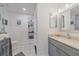 Clean bathroom with white tile floors, gray vanity, and a modern sink at 3711 118Th W St, Bradenton, FL 34210