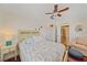 Light and airy bedroom with wood flooring, ceiling fan, and access to hall at 3711 118Th W St, Bradenton, FL 34210
