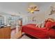 Bright bedroom with hardwood floors, ceiling fan, bay window, and a comfortable sitting area at 3711 118Th W St, Bradenton, FL 34210