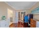 Open closet space connected to a bedroom and bathroom, featuring hardwood floors at 3711 118Th W St, Bradenton, FL 34210