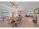 Open-concept dining room and living area filled with natural light and wood flooring at 3711 118Th W St, Bradenton, FL 34210